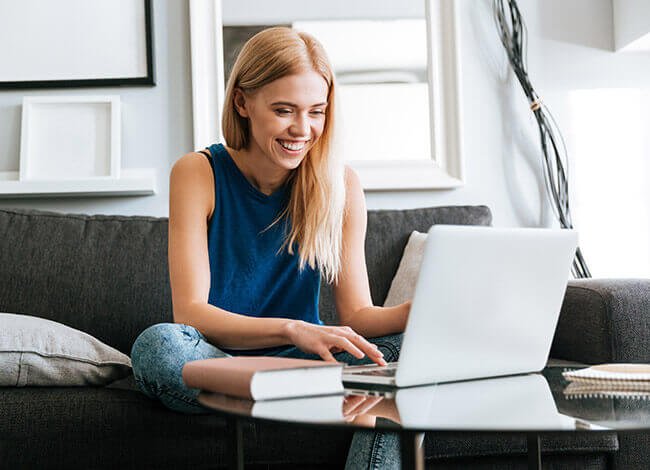 Blond girl on laptop at home